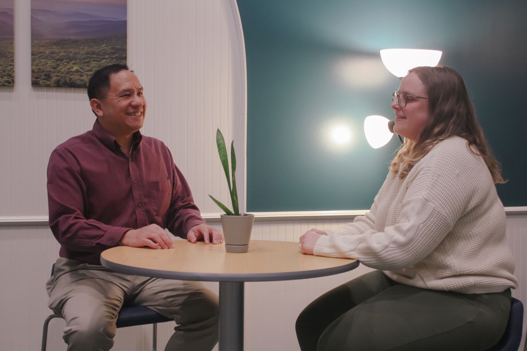 two people discussing at a desk
