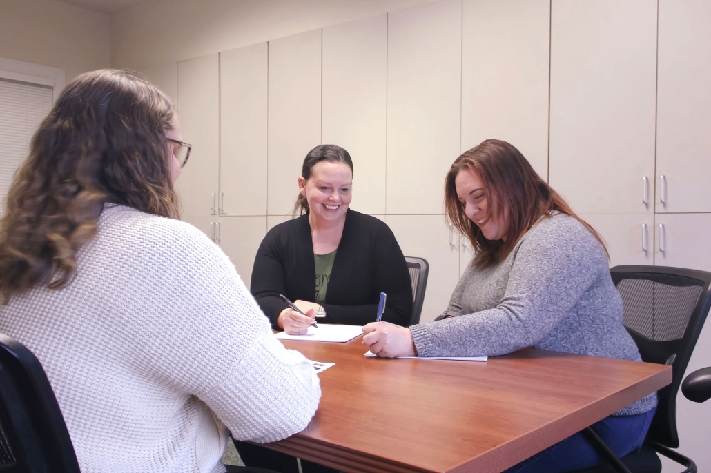 Three people sitting at desk